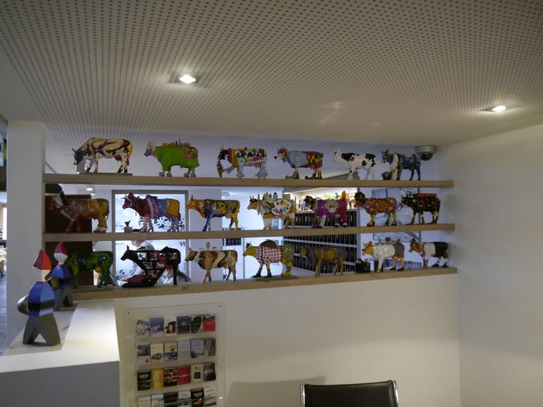 A variety of cows line up the lobby. 