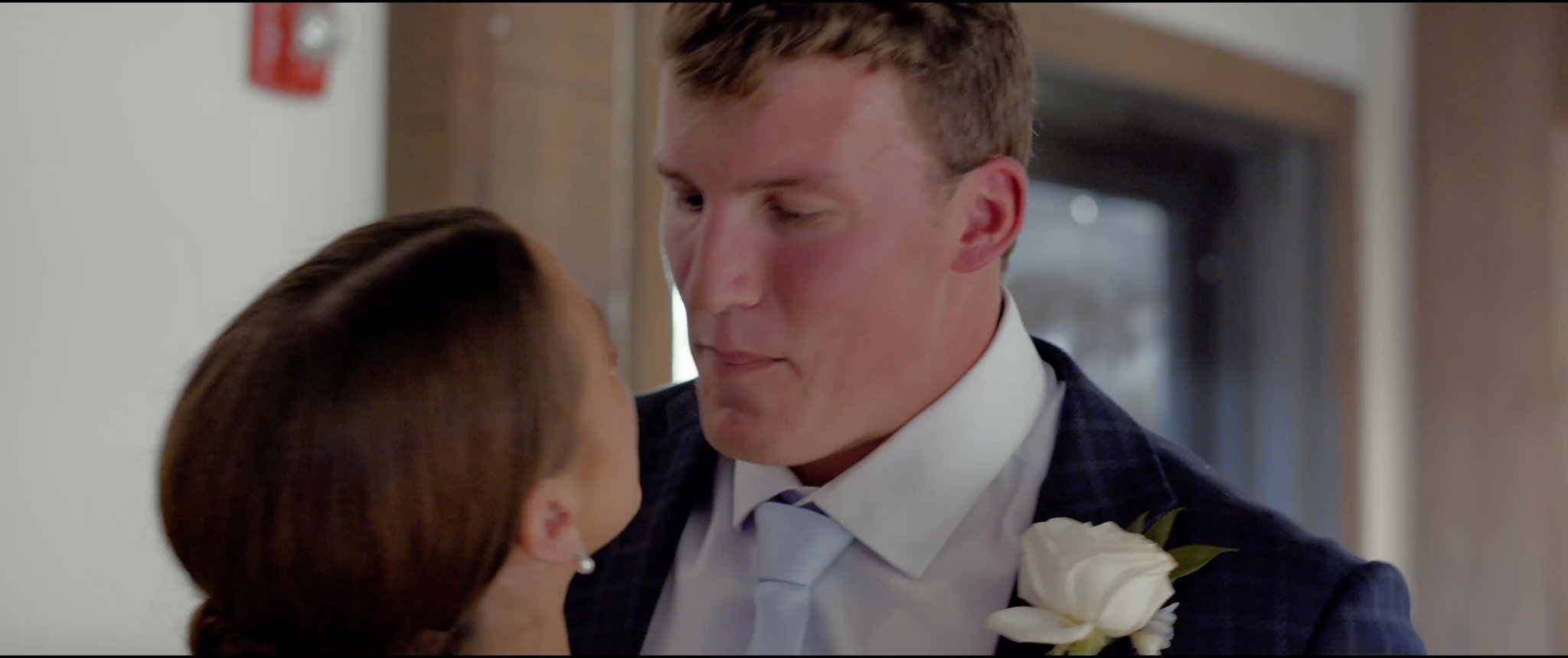Julianna and Jake cutting their wedding cake. Still from their Midsummer Productions wedding film.