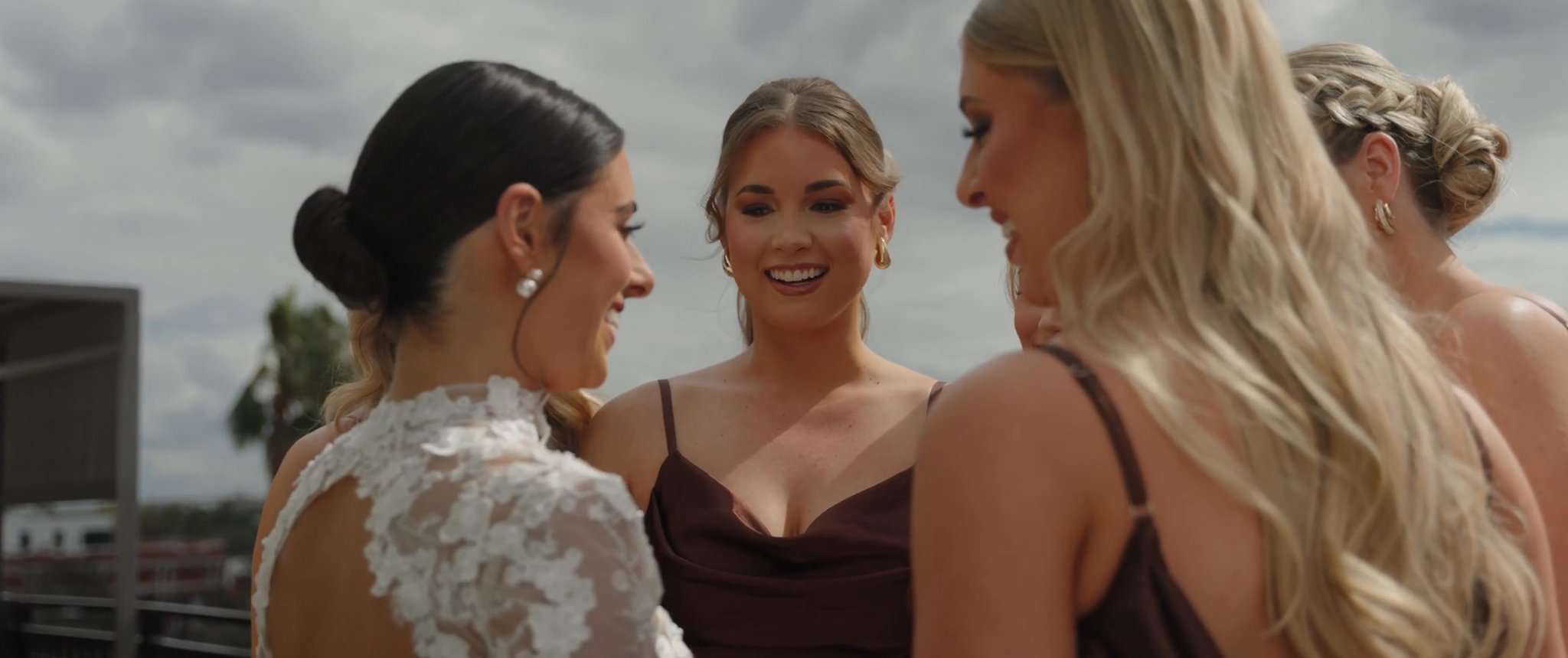 Ally talks with her bridesmaids after the dress reveal. Still from their Midsummer Productions wedding film.