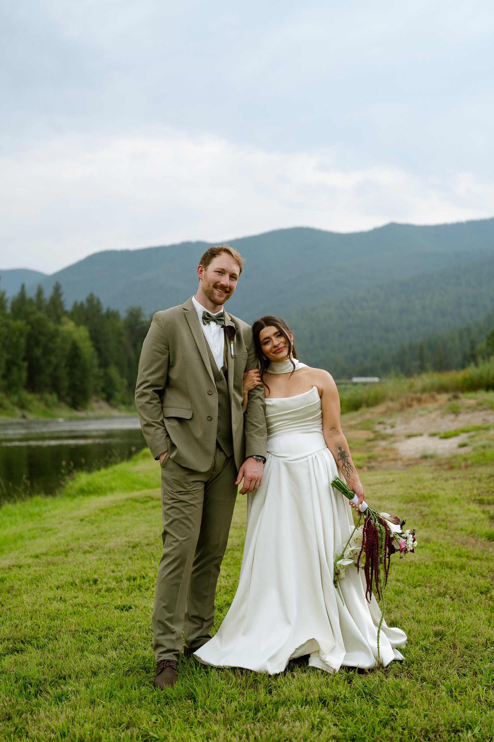 Madison and Brady together beside the river, with the Montana mountains behind them.