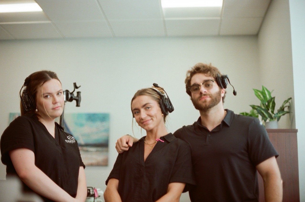 Three Midsummer crew members wearing headsets at Jordan and Evan’s Tampa wedding, photographed on film.