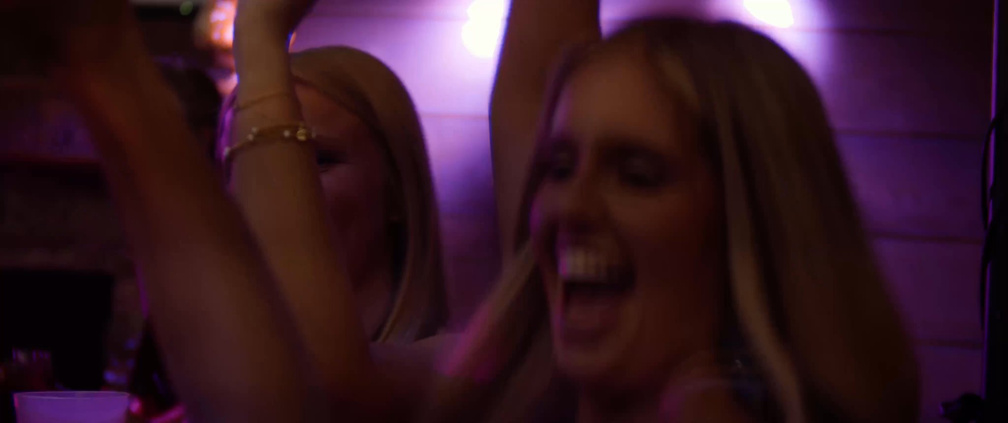 Julianna laughing on the reception dance floor. Still from their Midsummer Productions wedding film.
