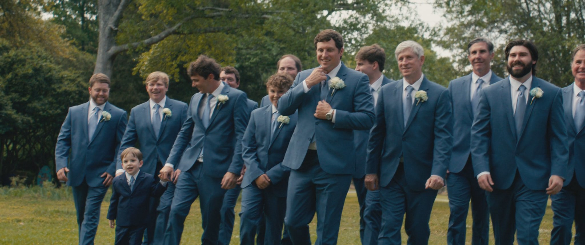 Cam and his groomsmen standing together outside. Still from their Midsummer Productions wedding film.