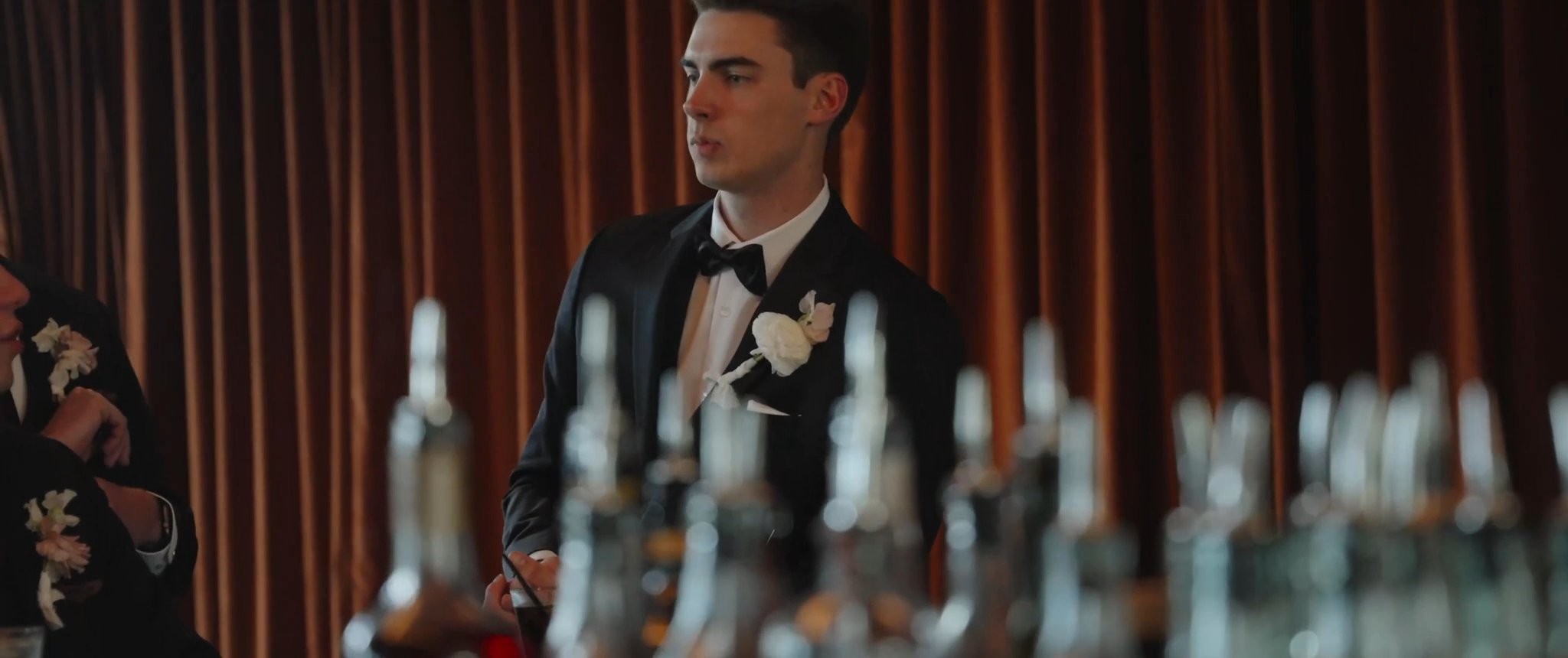 Jake getting ready in the hotel room. Still from their Midsummer Productions wedding film.