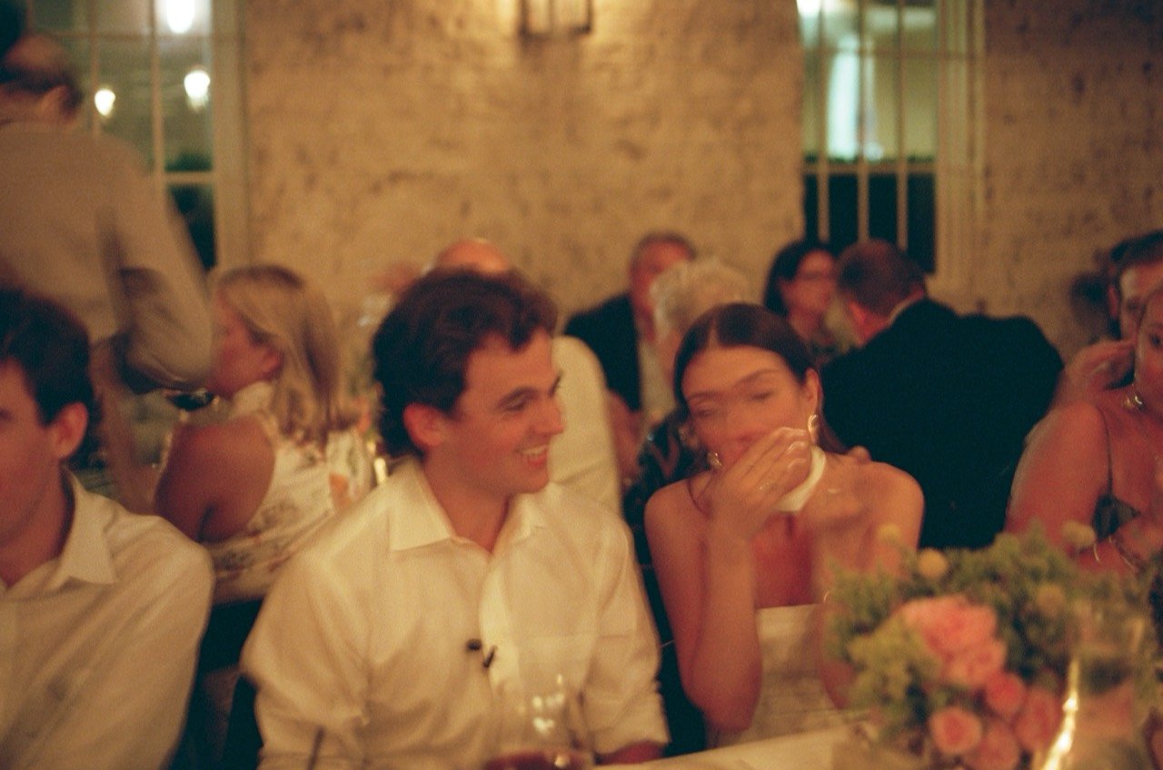 Brooklyn and David laugh together at their reception at New Water Farms, photographed on film.