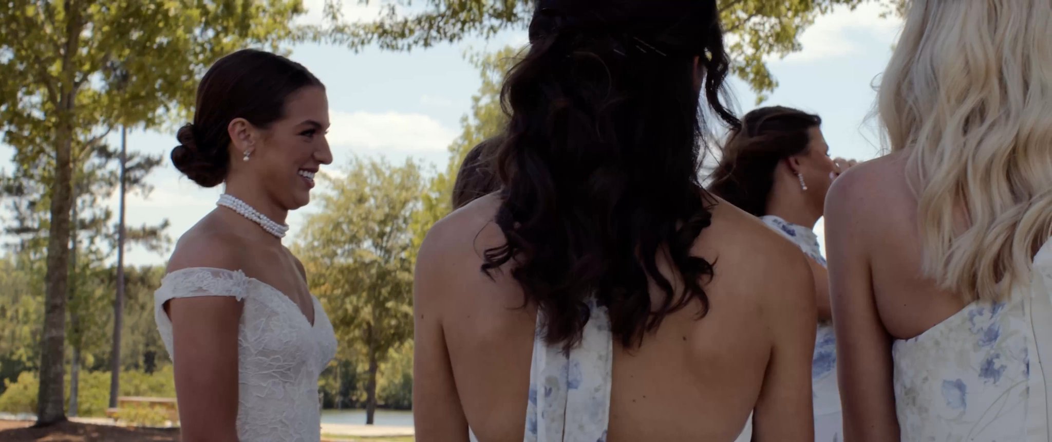 Julianna shows her wedding dress to her bridesmaids. Still from their Midsummer Productions wedding film.