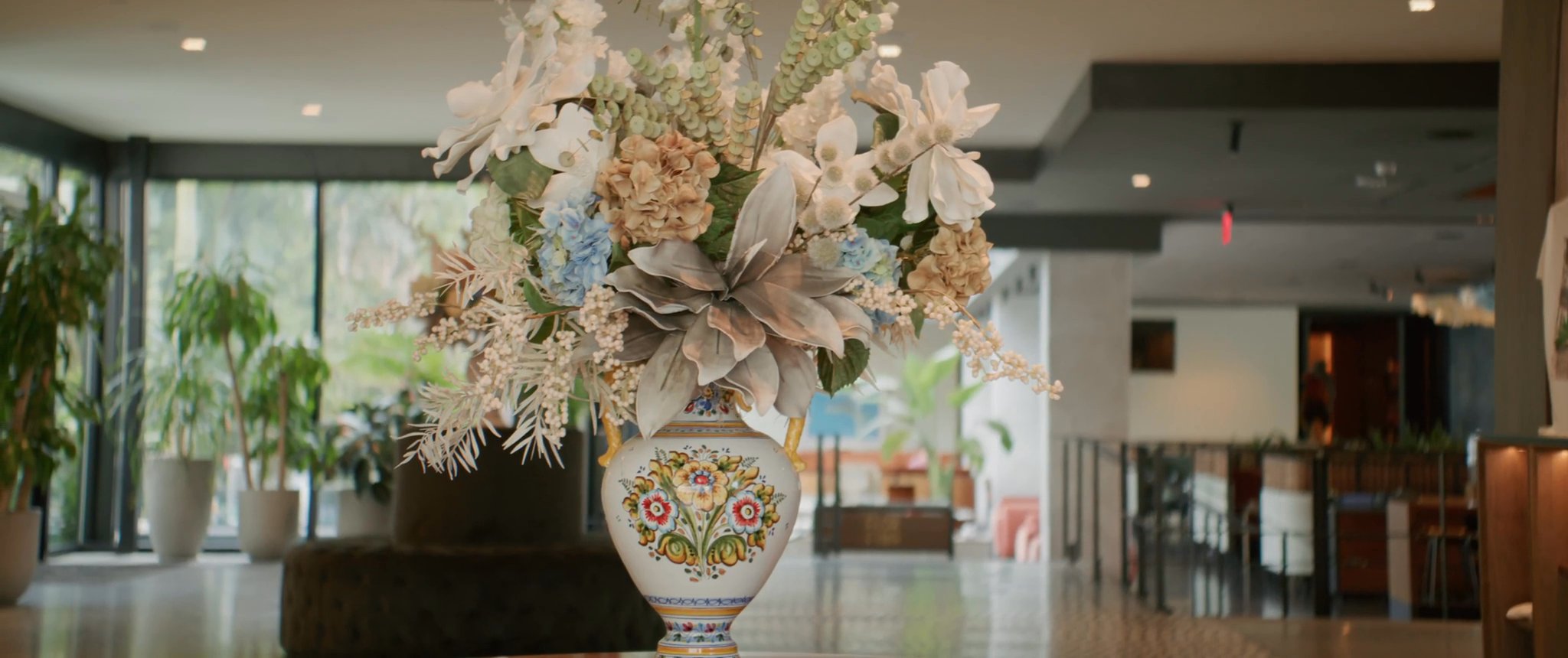 The floral arrangement in the hotel lobby. Still from their Midsummer Productions wedding film.