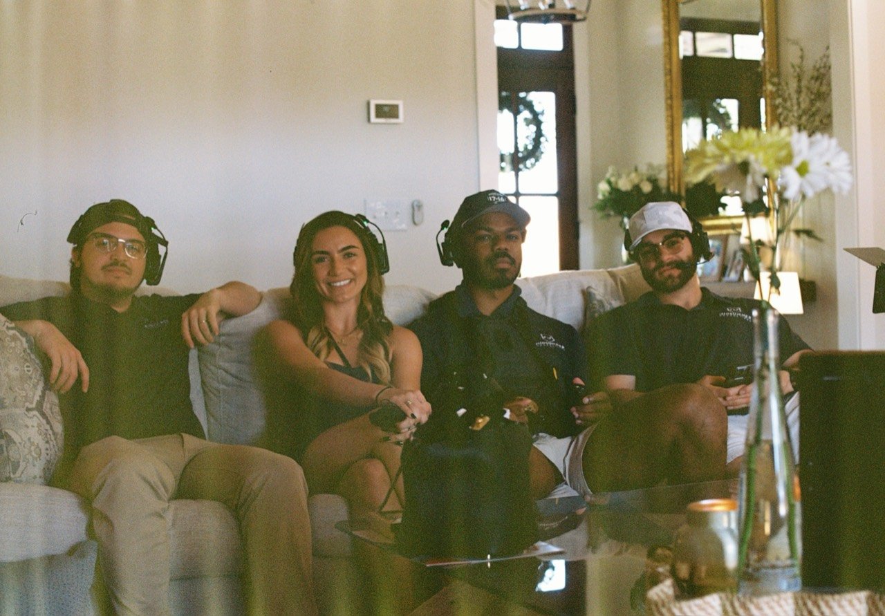 Four Midsummer crew members wearing headsets on a couch at Raley and Drew’s Dalrymple Farms wedding, photographed on film.