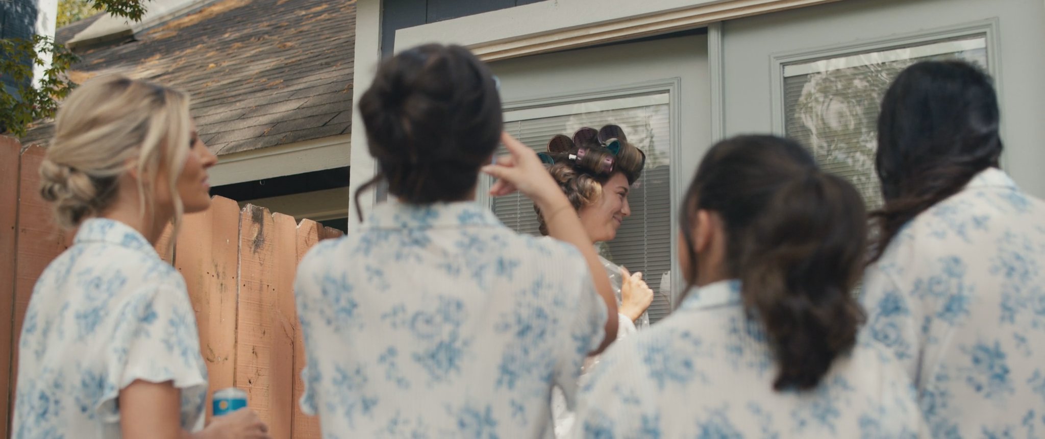 Montana celebrating with her bridesmaids in their matching pajamas. Still from their Midsummer Productions wedding film.