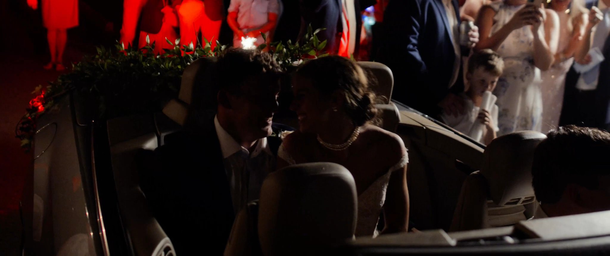 Wedding guests celebrating together at the reception. Still from their Midsummer Productions wedding film.