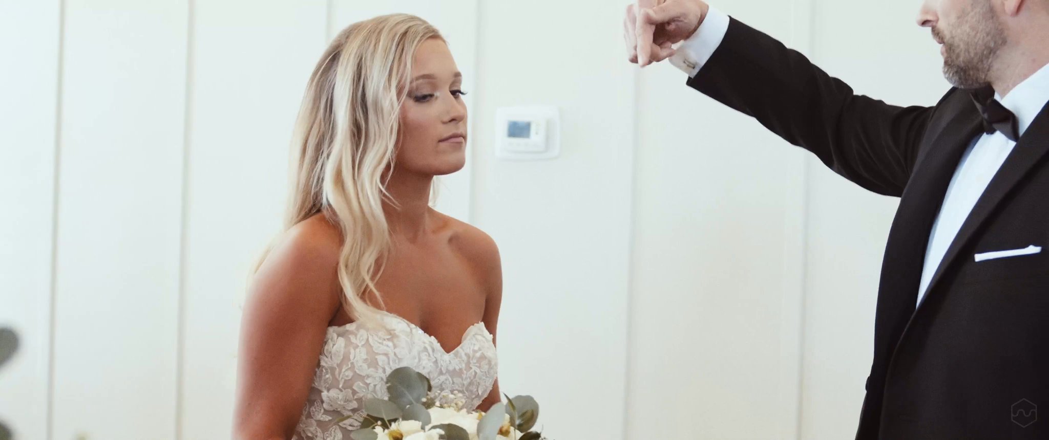 Madalyn shows her wedding dress to her dad during their first look. Still from their Midsummer Productions wedding film.