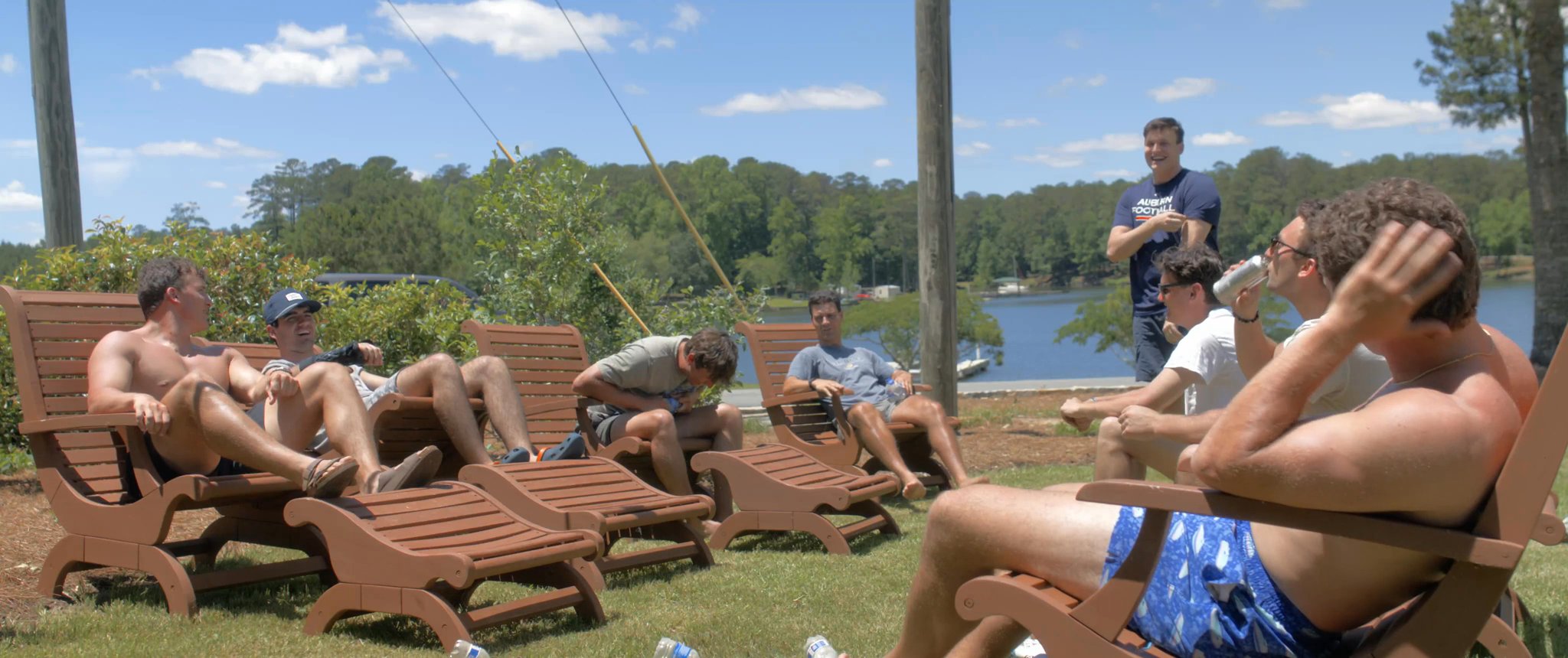 The groomsmen hanging out in lawn chairs beside the lake. Still from their Midsummer Productions wedding film.