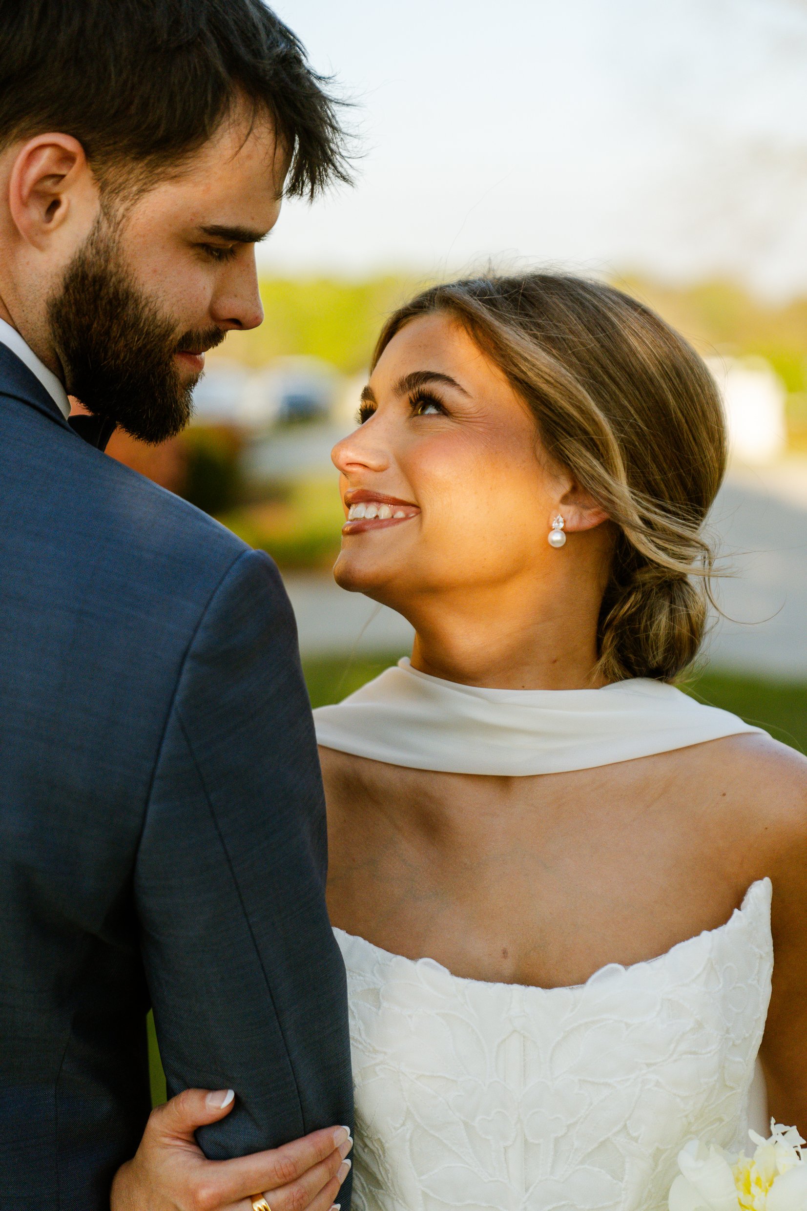 Close view of Matthew looking down at Joley while she smiles up at him in warm evening light.