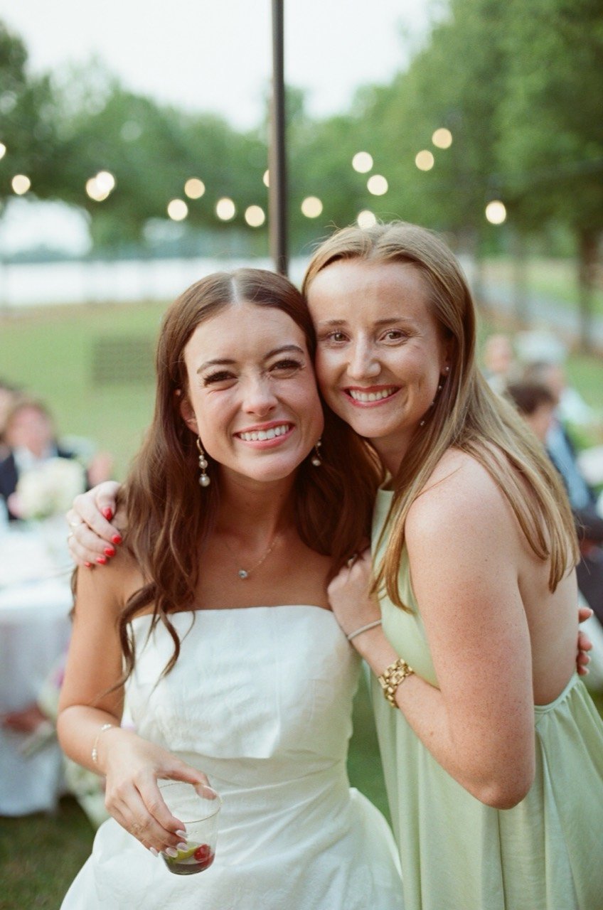 Brooklyn and a friend smile together at New Water Farms, photographed on film.