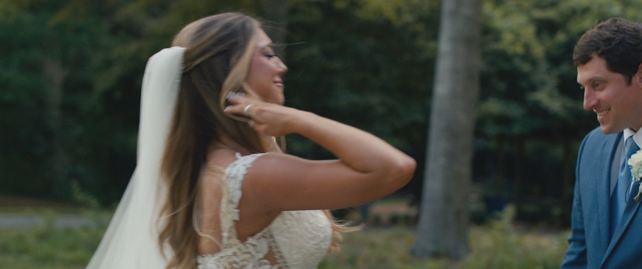 Montana and Cam laughing together during their first look. Still from their Midsummer Productions wedding film.