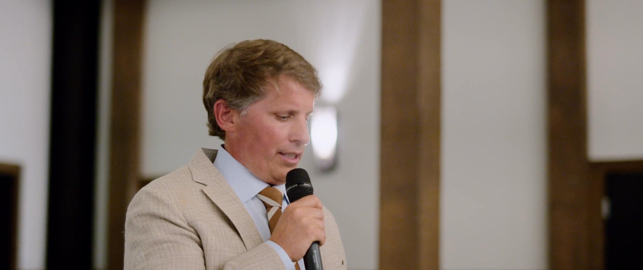 A guest gives a speech at the wedding reception. Still from their Midsummer Productions wedding film.