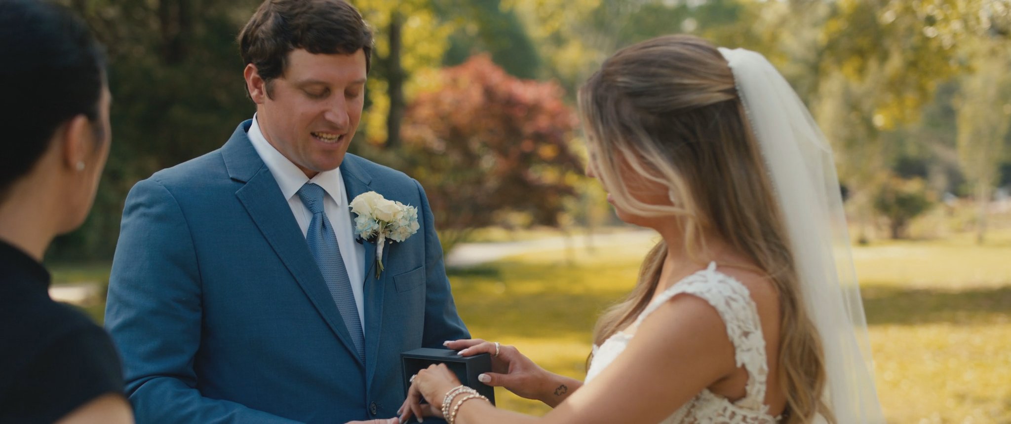Montana gives Cam his gift during their first look. Still from their Midsummer Productions wedding film.