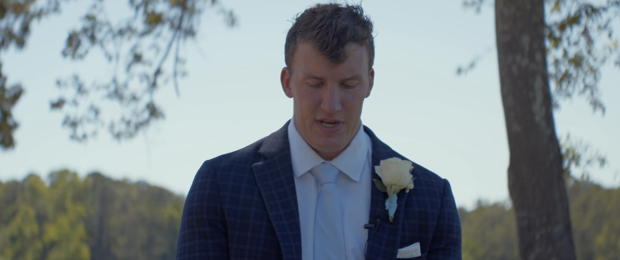 Jake looks down during the wedding ceremony. Still from their Midsummer Productions wedding film.