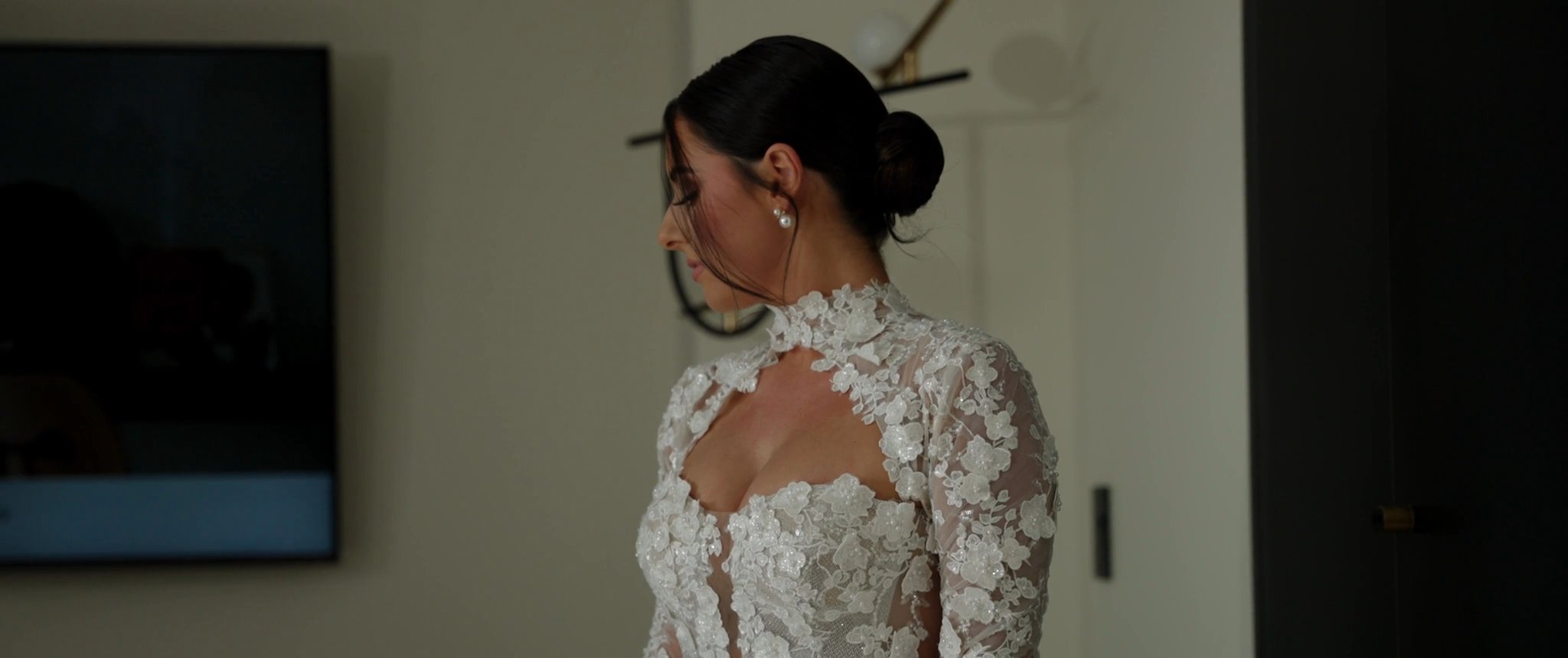 Ally in her lace wedding dress. Still from their Midsummer Productions wedding film.