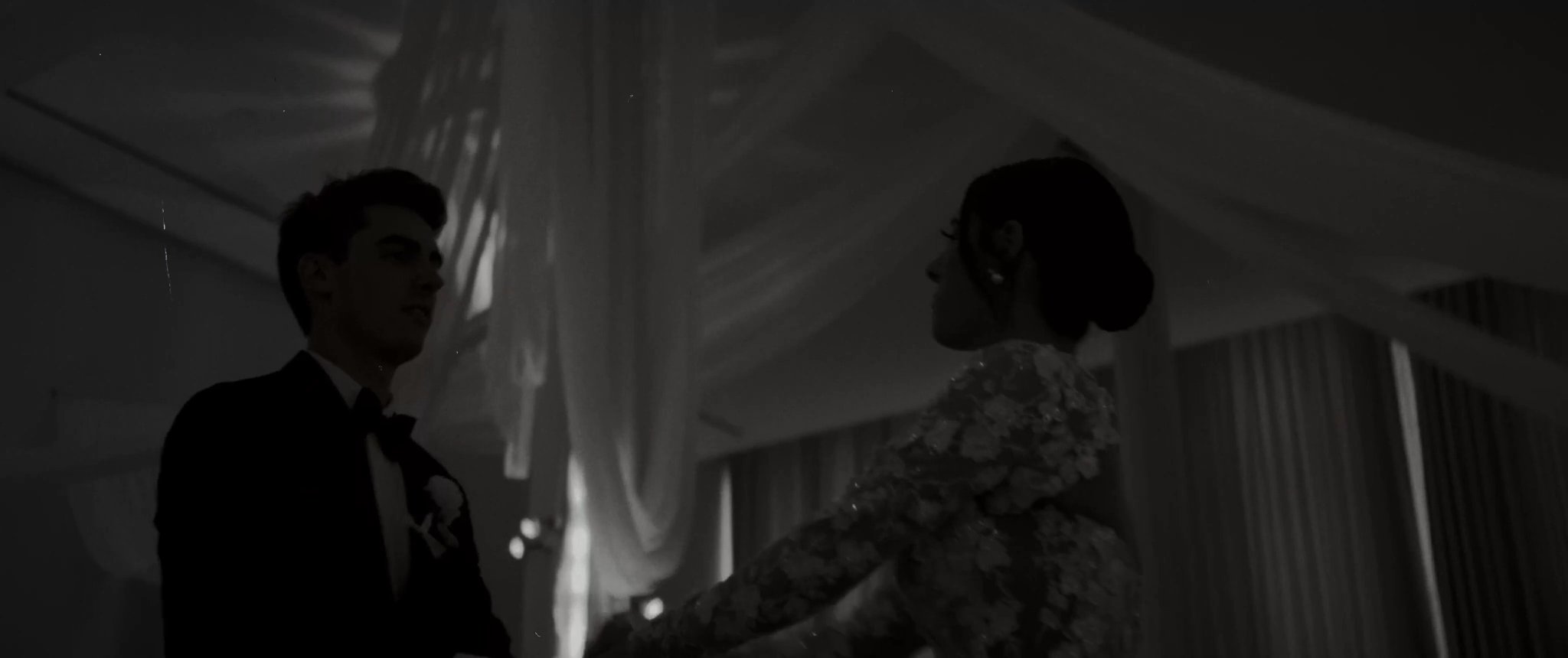 A black-and-white moment from Ally and Jake’s first dance. Still from their Midsummer Productions wedding film.