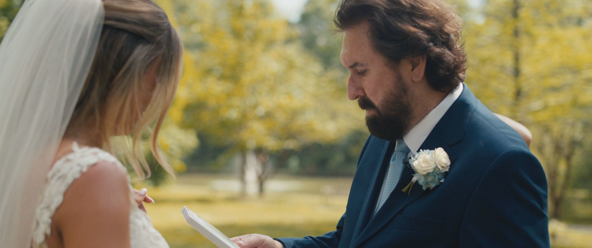Montana’s dad reading a letter during their first look. Still from their Midsummer Productions wedding film.