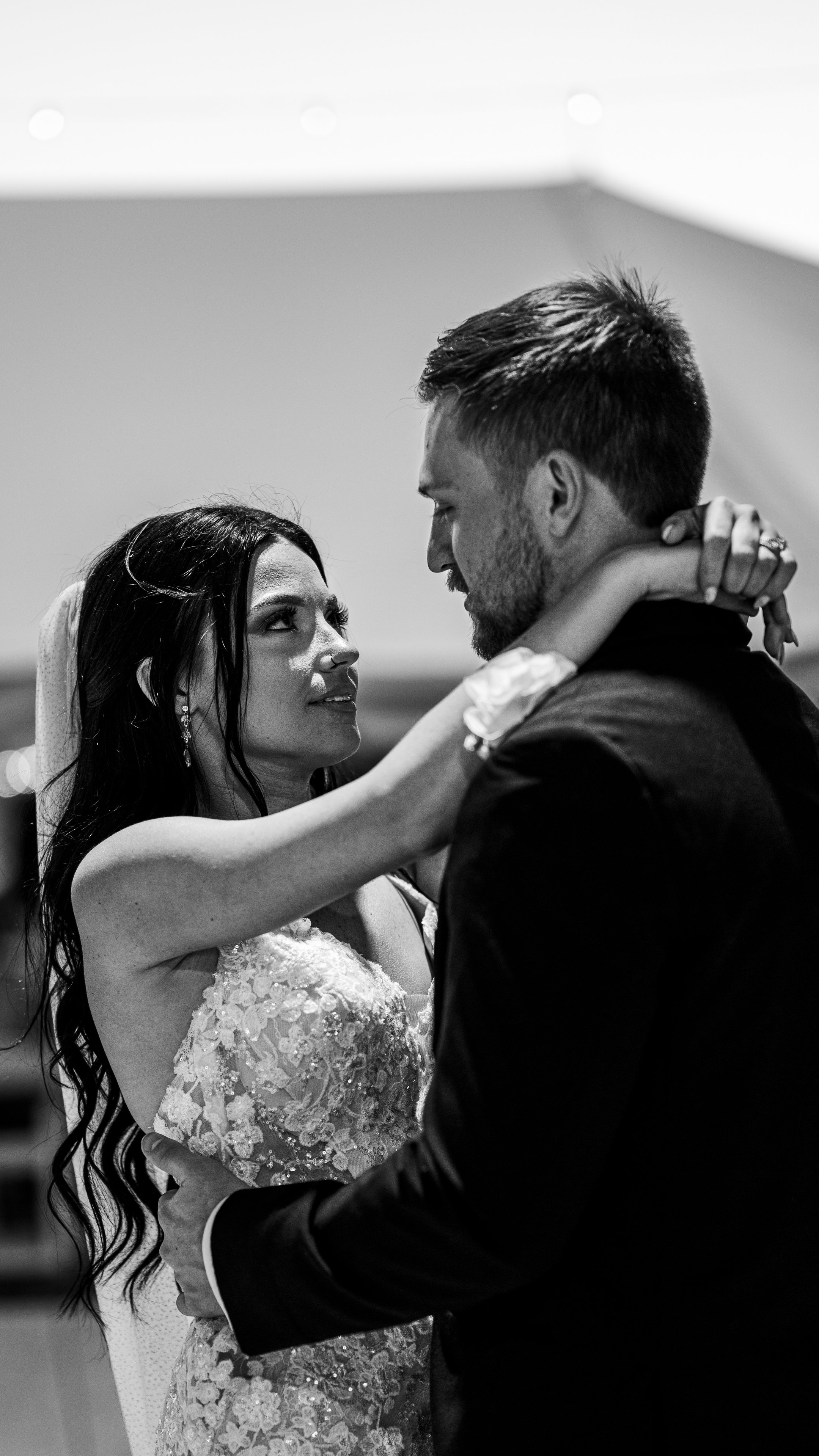 In black and white, Kenadee and Corey dancing, she looking up at him with her arm around his neck.