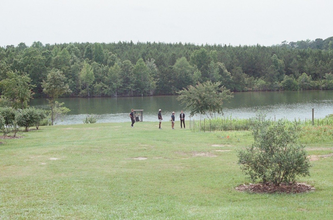 The Midsummer crew filming on the lawn beside the lake at New Water Farms, photographed on film.