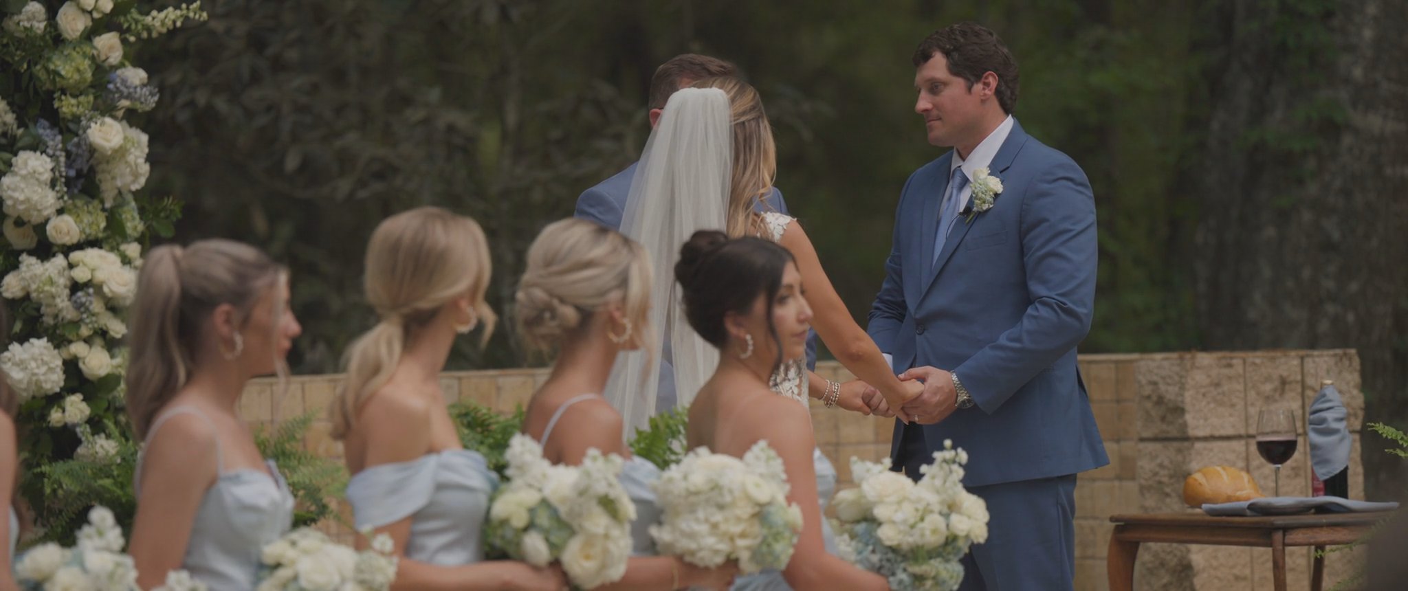 Montana and Cam facing each other during their vows. Still from their Midsummer Productions wedding film.