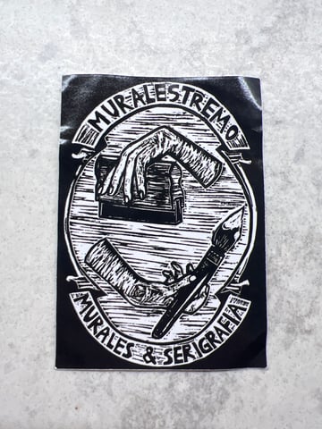 A high-contrast black and white rectangular sticker featuring woodcut-style illustrations of artistic labor. It showcases the tools of the trade for muralism and screen printing, framed by bold typography.
