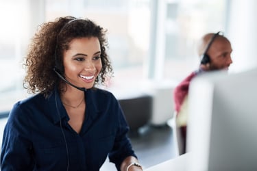 Virtual assistant tracking time and smiling in front of a computer