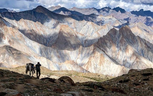 Hikers overlooking colorful mountain landscape