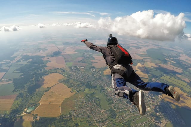 Skydiver fly over the clouds