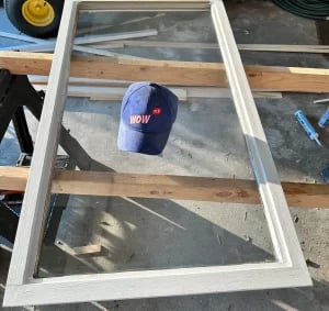 Window screen frame repair in progress with tools and equipment at Charlotte repair workshop