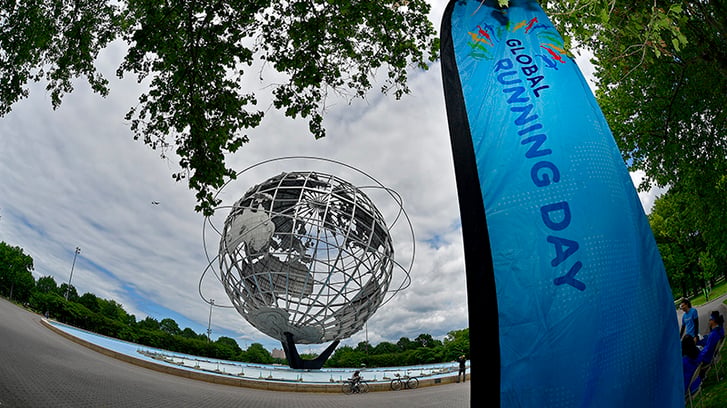 Global Running Day banner in Flushing Meadows Park
