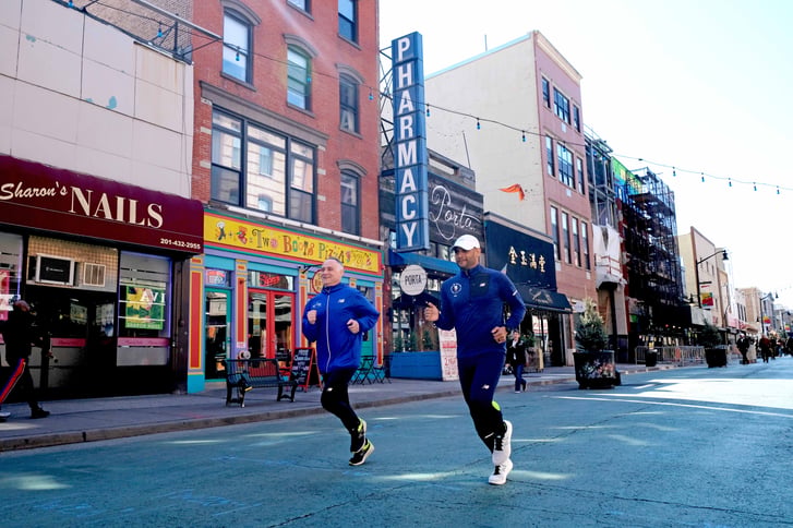 NYRR President and CEO Michael Capiraso and Director of Event Development & Production Ro Crispin running in Downtown Jersey City