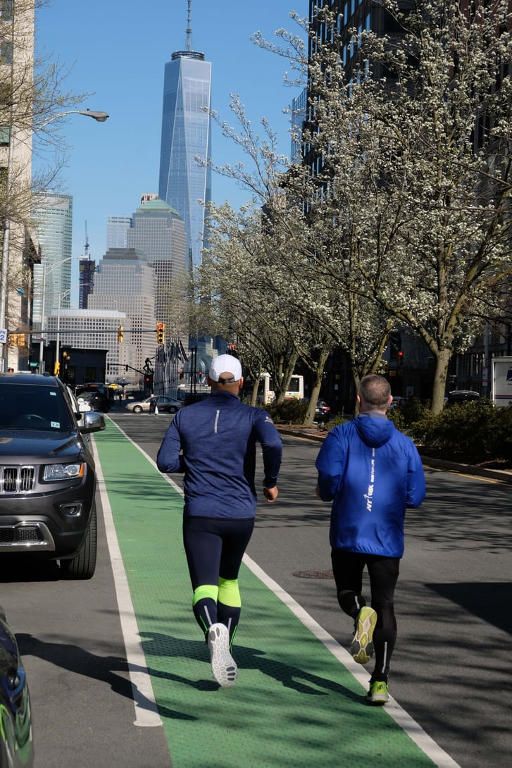 NYRR President and CEO Michael Capiraso and Director of Event Development & Production Ro Crispin running in Downtown Jersey City