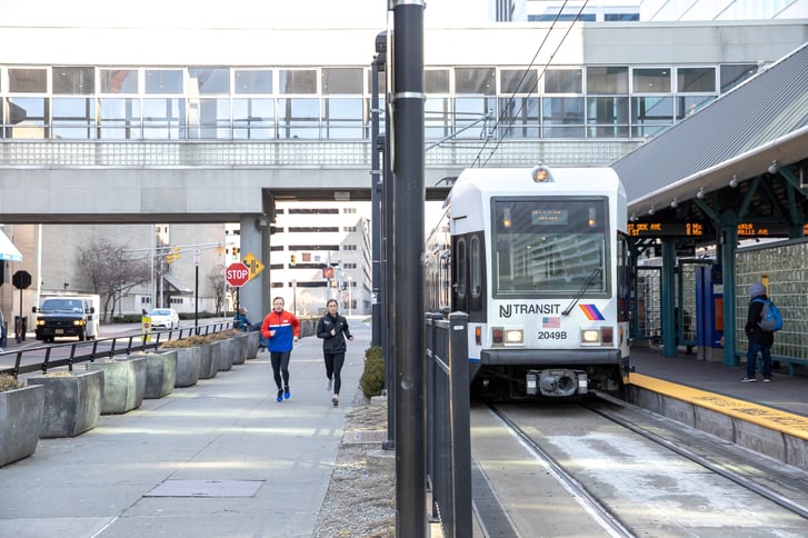Two runners near the Hudson-Bergen Light Rail station at Newport in Jersey City