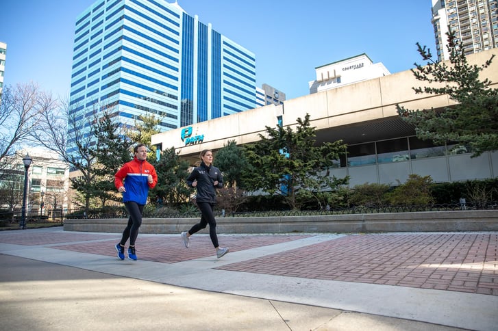 Two runners outside of the Newport PATH station in Jersey City