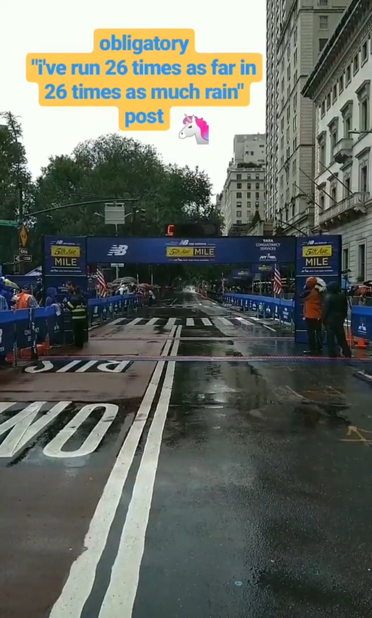 An image of the 2018 New Balance 5th Avenue Mile finish line with text overlaid: "obligatory 'i've run 26 times as far in 26 times as much rain' post"