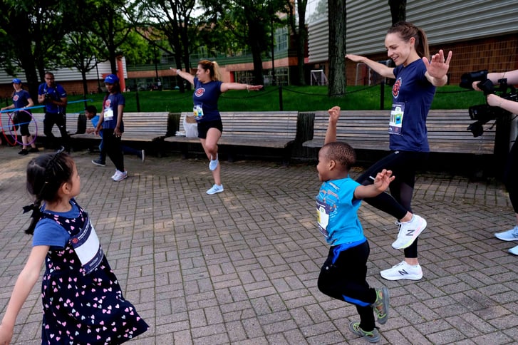 Jenny Simpson and Rising New York Road Runners students playing a game of Animal Tag