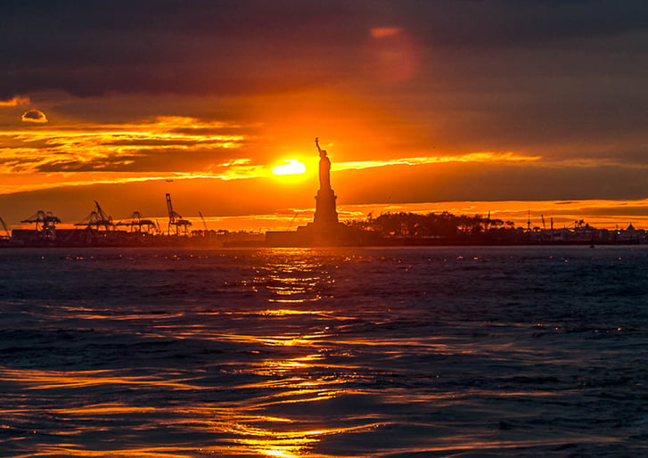 Sunset behind the Statue of Liberty