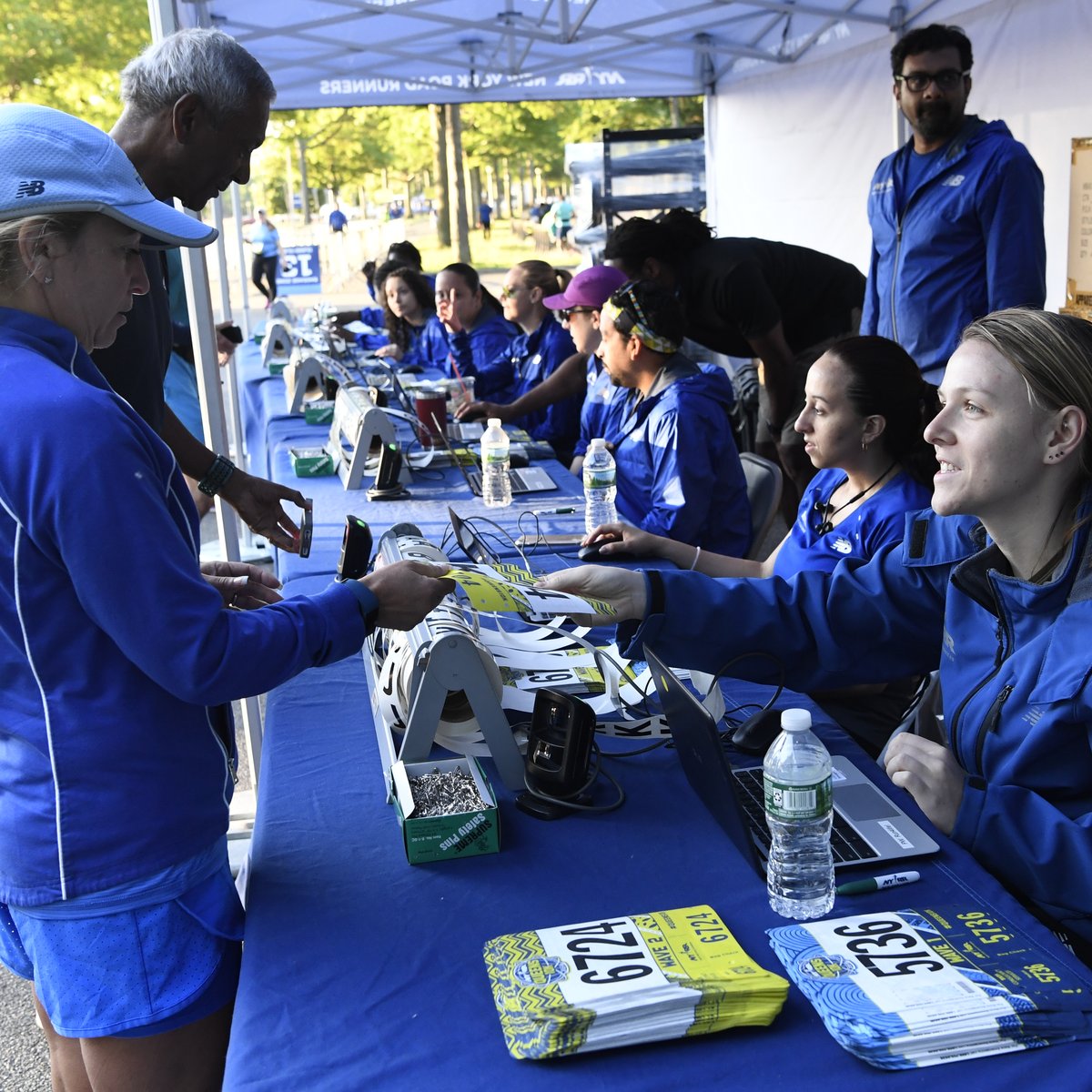 Runners picking up their bib numbers at the NYRR Queens 10K