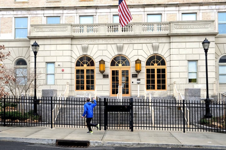 Michael Capiraso running past the Margaret Hague Maternity Hospital building in Jersey City, NJ