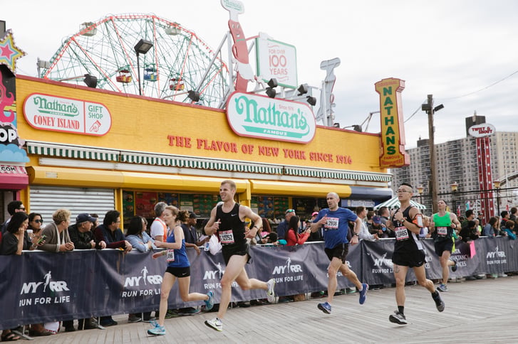 Brooklyn Half runners passing Nathan's on the Coney Island Boardwalk