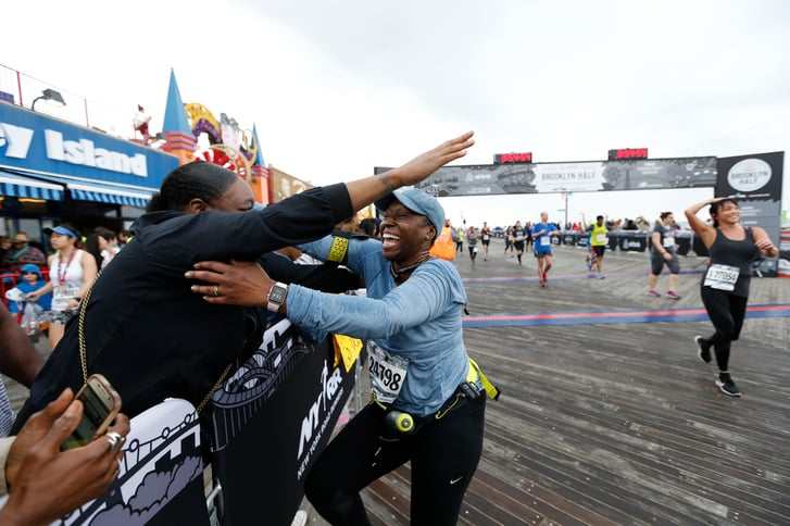 A runner hugging a spectator at the end of the Popular Brooklyn Half