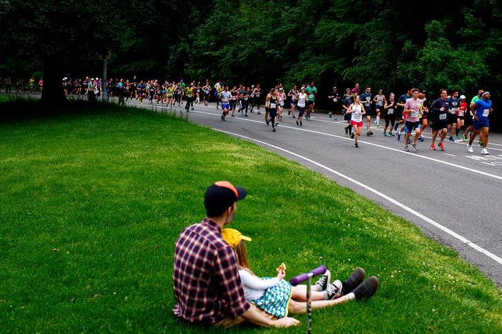 A father watching a race in Prospect Park