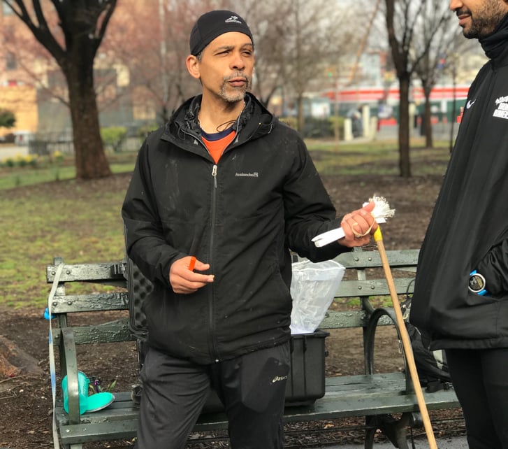 Rolando passes out timing tags to runners and walkers.