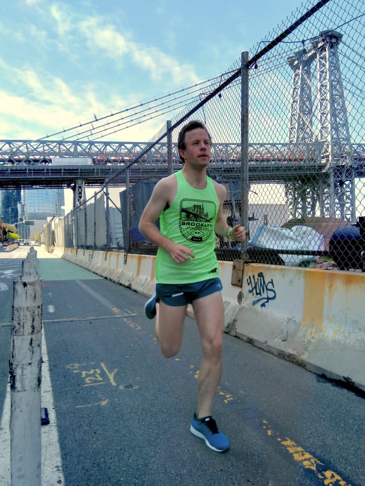 A runner on Kent Avenue in Brooklyn with the Williamsburg Bridge in the background