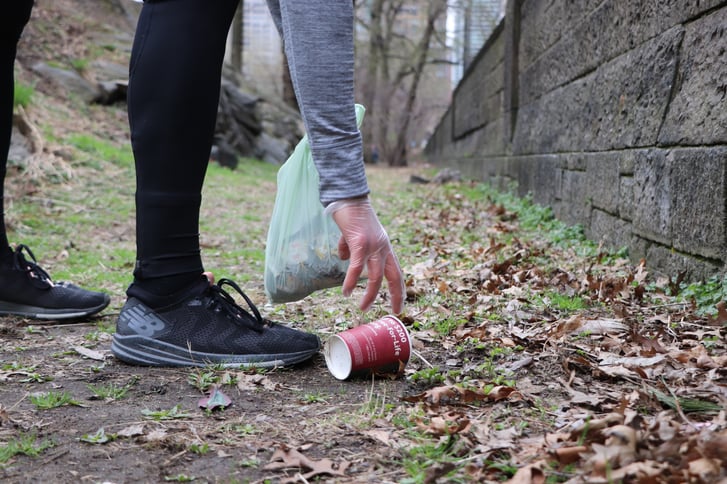 Runner picking up trash in Central Park
