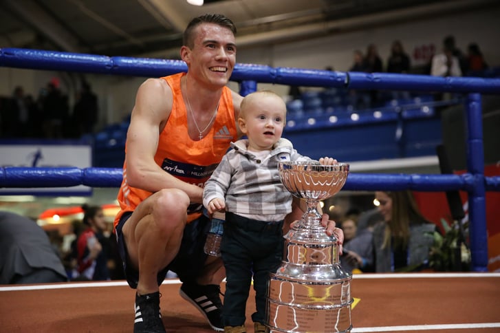 Chris O'Hare with his son and the NYRR Wanamaker Mile trophy at the NYRR Millrose Games